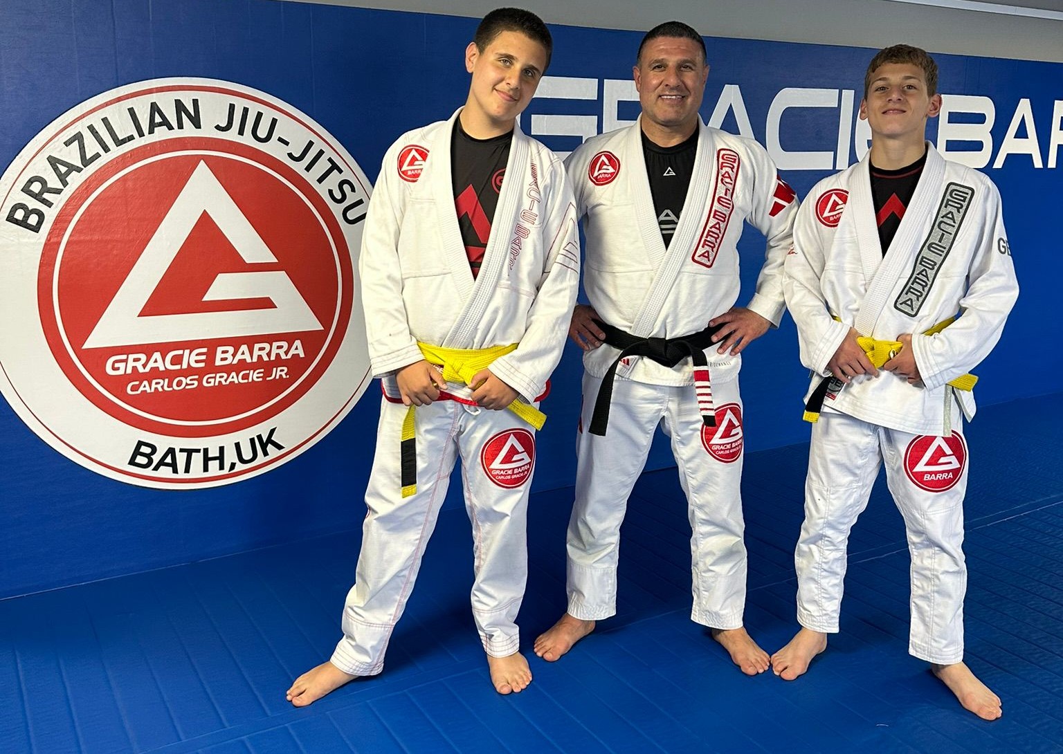 Training partners practicing guard recovery and technical blue belt requirements on the mats