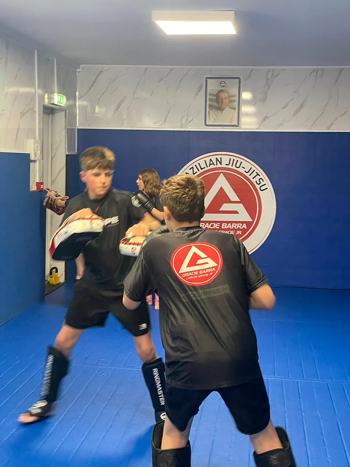 Pad work during youth striking training